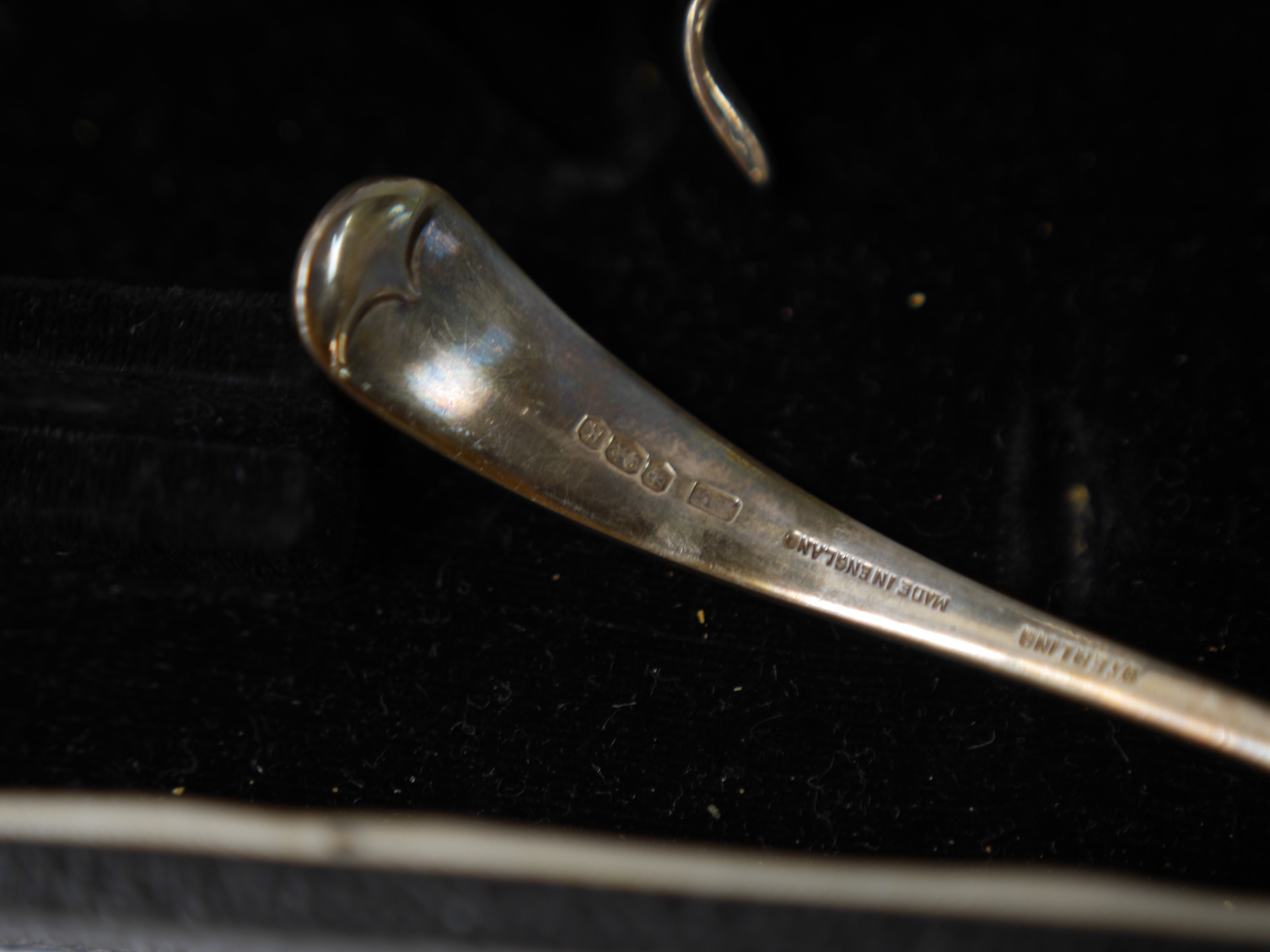 A cased Elizabeth II silver sauce boat and spoon, by Viners Ltd, Sheffield, 1952/5 and one other silver sauce boat. Condition - poor to fair